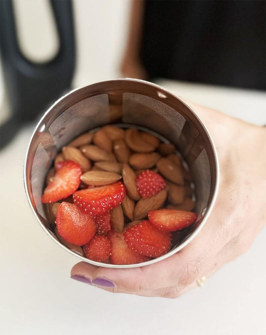 fresh almonds and sliced strawberries in a filter basket